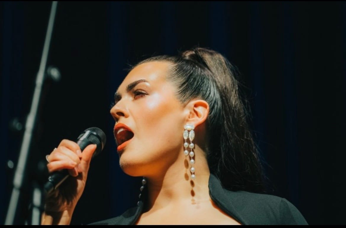 Dana in performance, close portrait mid-phrase